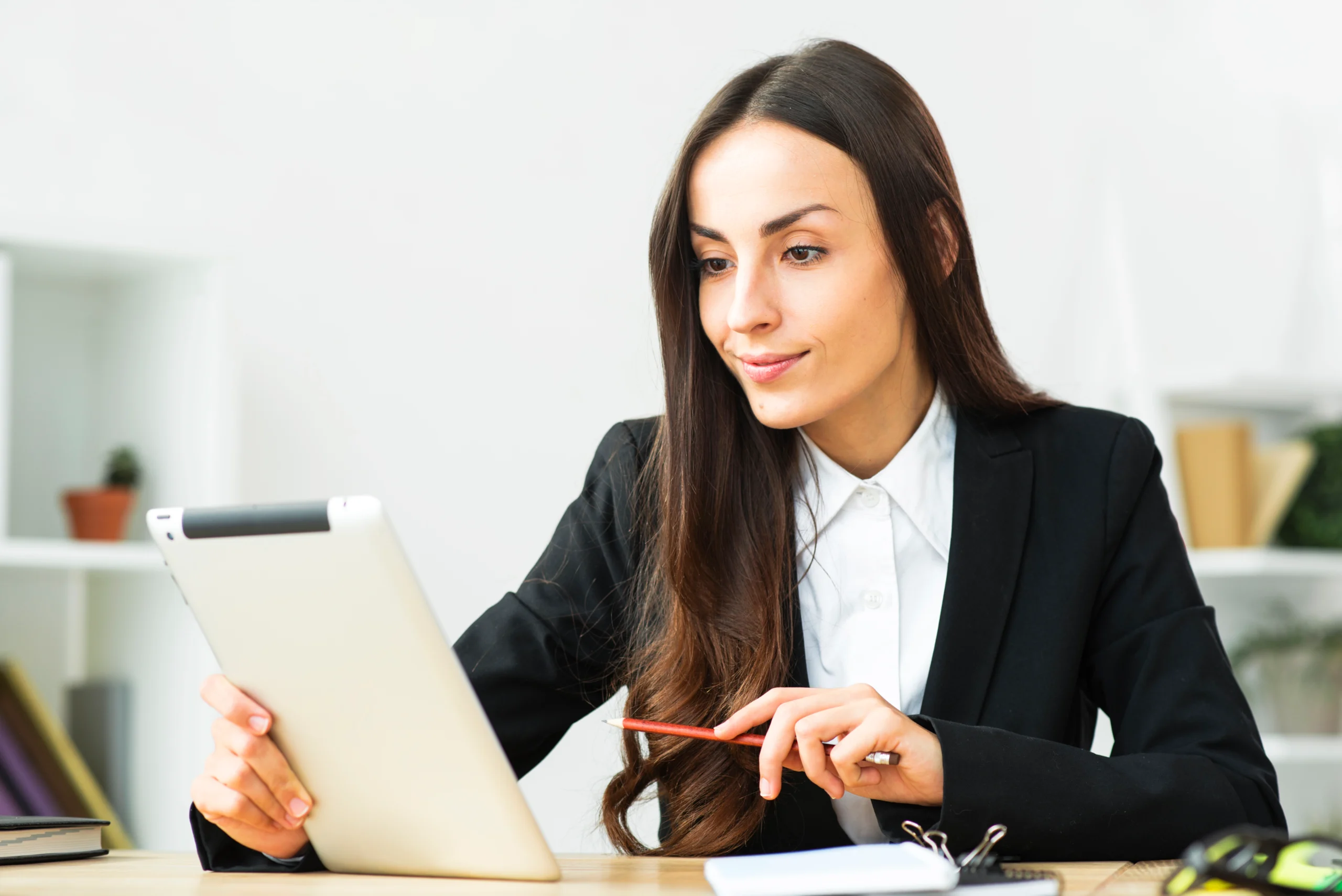 confident-smiling-young-businesswoman-looking-digital-tablet-office