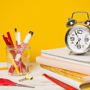 back-school-concept-clock-pile-books-scaled.jpg